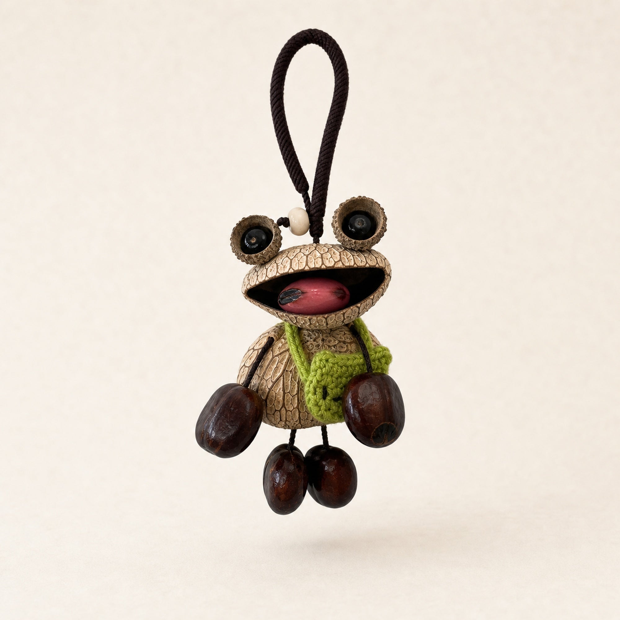 YUNOVA Big-Eye Frog natural seed pod hanging charm on a clean studio background