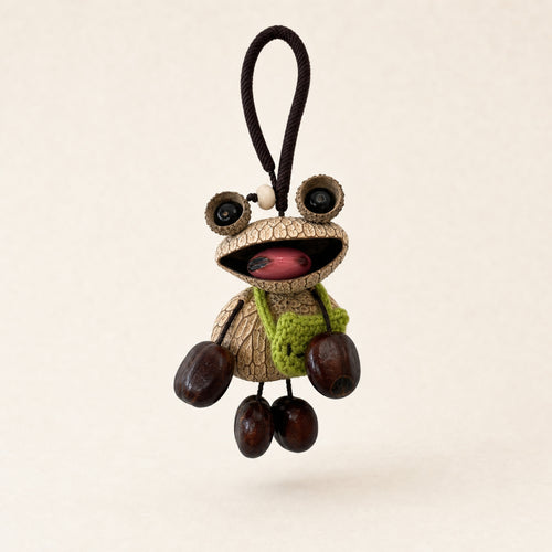 YUNOVA Big-Eye Frog natural seed pod hanging charm on a clean studio background