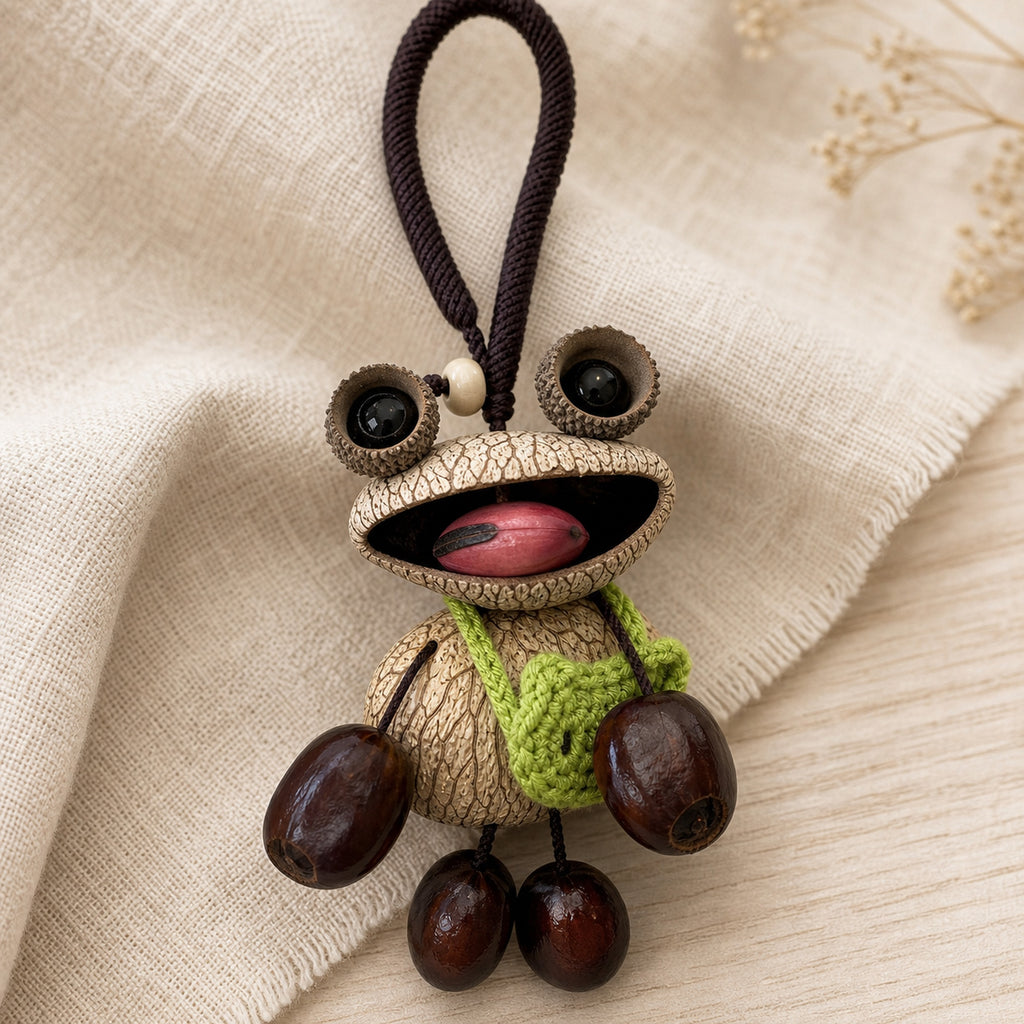 Close-up material detail of YUNOVA Big-Eye Frog natural shell and seed pod charm