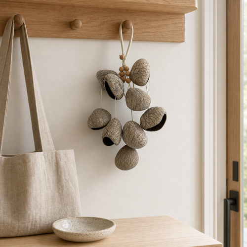 YUNOVA Dark Fruit Shell wind chime hanging on an entryway wooden peg rail