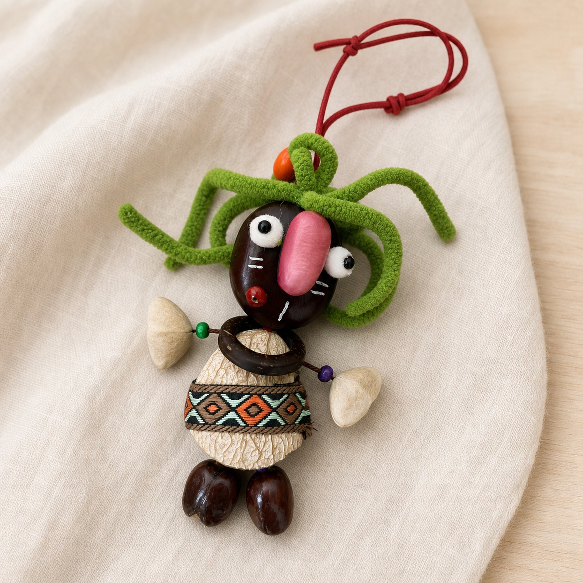 Close-up material detail of YUNOVA Dark Pod Doll natural seed and shell ornament