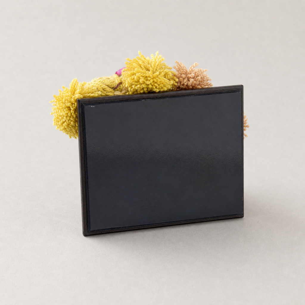 Back view of the flat black magnetic panel on a YUNOVA framed gourd doll magnet
