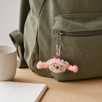 YUNOVA pod doll charm on a sage canvas backpack