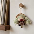 YUNOVA pod doll magnetic charm hanging from an oak peg in a reading nook